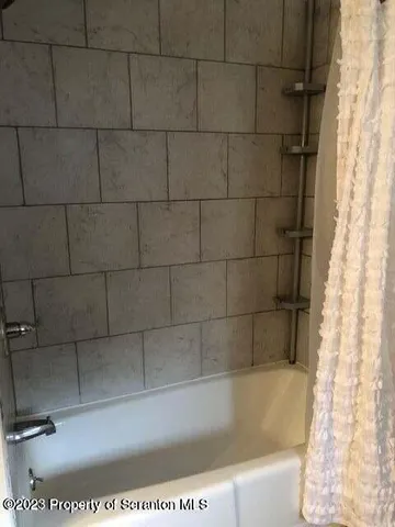 a bath tub sitting next to a shower