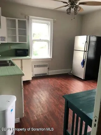 a view of a room with furniture and a window