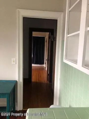 a view of a hallway with a door