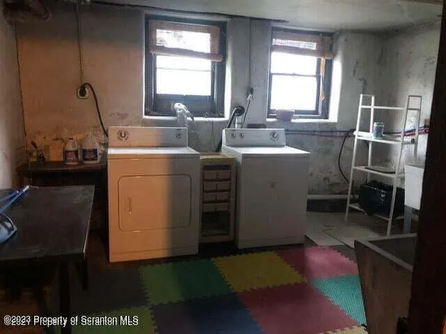a living room with a couch wooden floor and a table