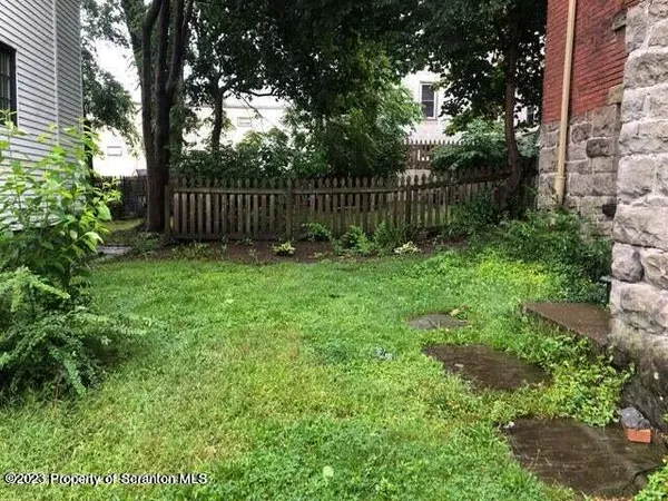 a view of garden with wooden fence