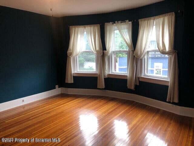801 Prescott Avenue Scranton, PA 18510 - Photo 8 of 26 a view of an empty room with wooden floor and a window