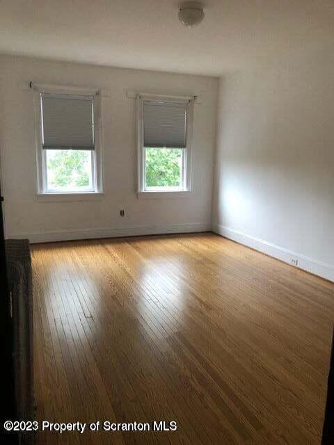 801 Prescott Avenue Scranton, PA 18510 - Photo 10 of 26 an empty room with wooden floor and windows