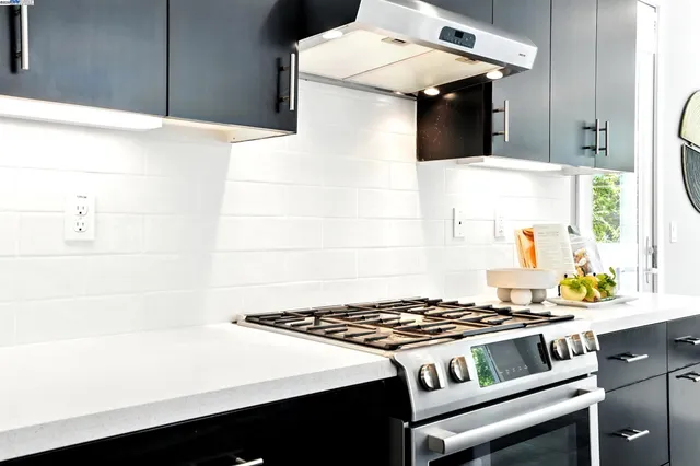 a white stove top oven sitting inside of a kitchen
