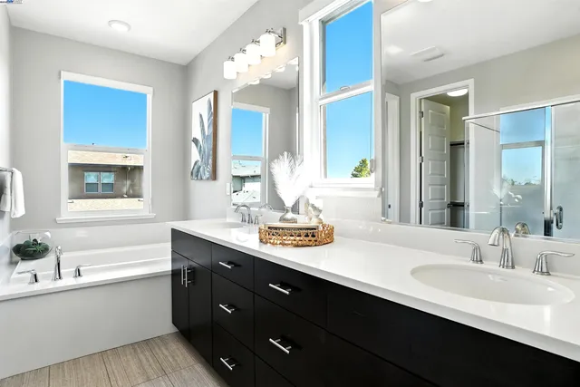 a white bath tub sitting in a bathroom next to a window
