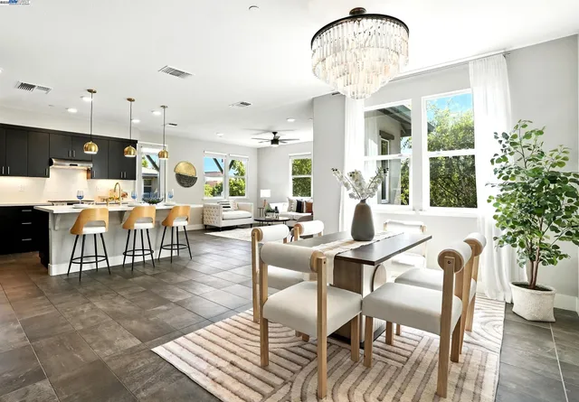 a living room with furniture a chandelier and a chandelier