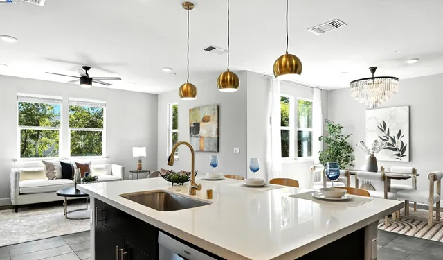 a kitchen with a sink a counter and living room view