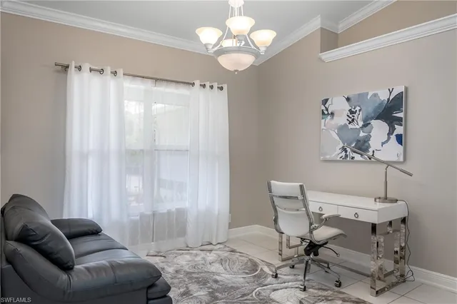 a living room with furniture a chandelier and a window