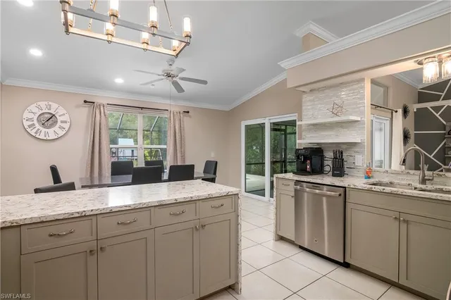 a kitchen with granite countertop stainless steel appliances a sink and cabinets