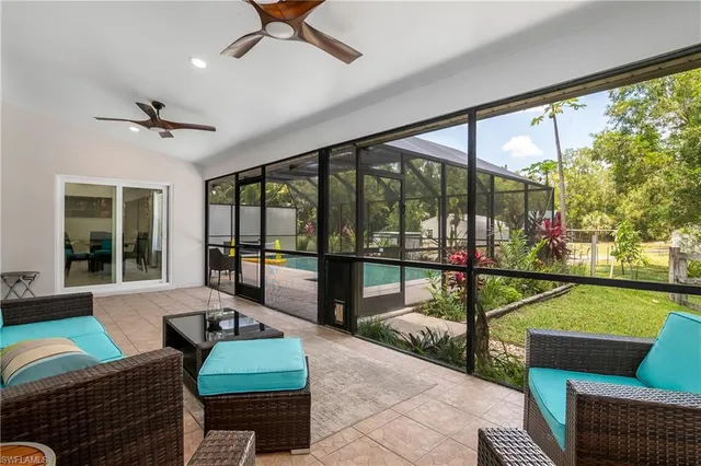a living room with furniture and a floor to ceiling window