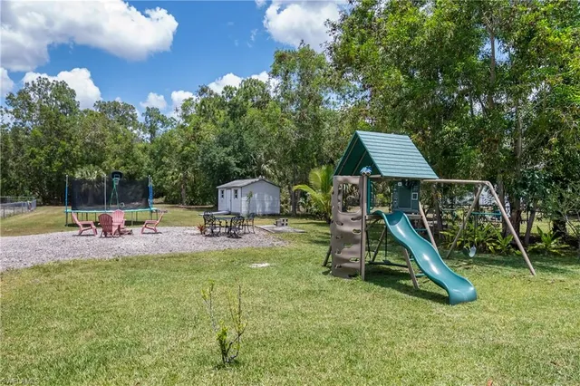 a view of a house with backyard and a slide