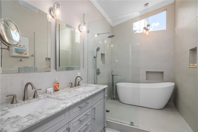a bathroom with a double vanity sink a mirror and a bathtub