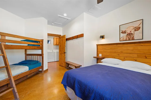 a bedroom with a bed and a painting on the wall