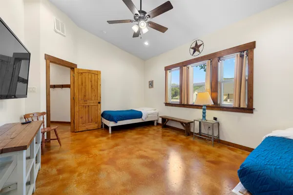 a bedroom with furniture and a window