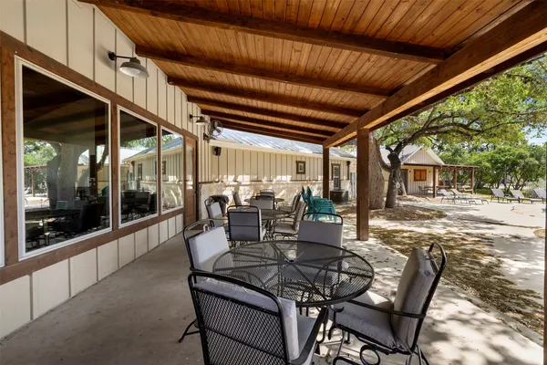 a view of a patio with table and chairs and potted plants