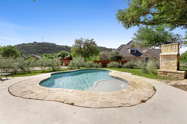 a view of a swimming pool with a yard