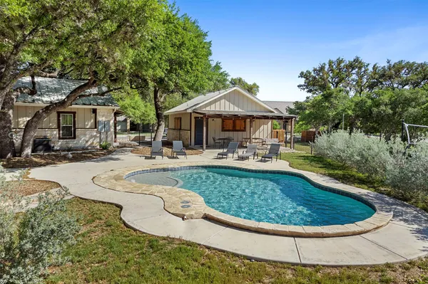 a view of a swimming pool with outdoor seating