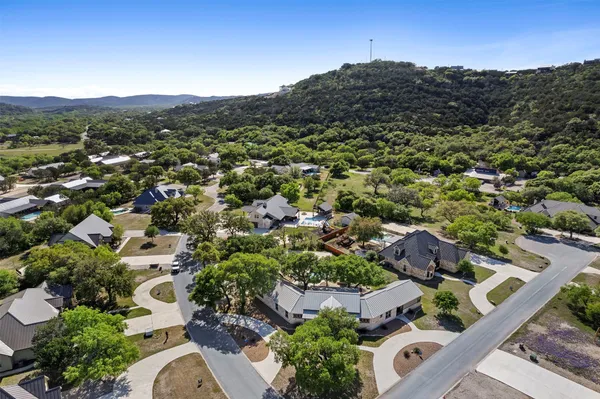 a view of a patio with table and chairs potted plants with large tree