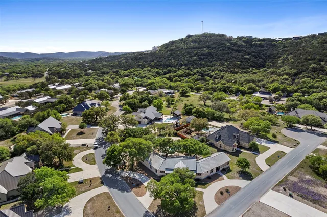 a view of a patio with table and chairs potted plants with large tree