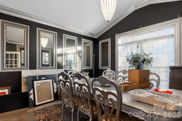 a bedroom with a bed and a view of kitchen