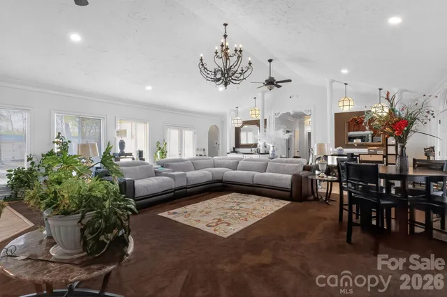 a living room with furniture and a chandelier