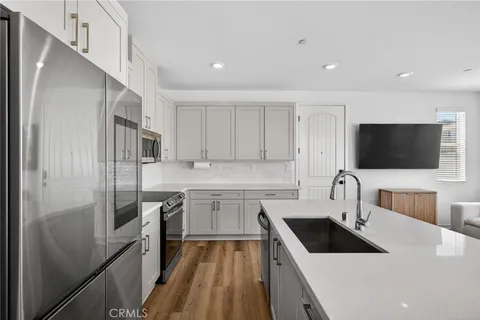 a kitchen with a sink stove and refrigerator