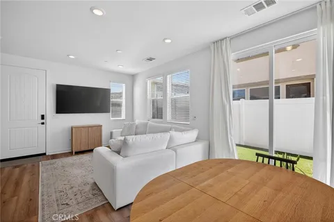 a bedroom with bed tv and window