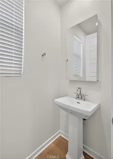 a bathroom with a sink a mirror and a toilet