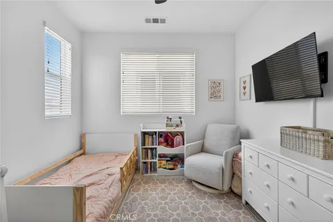 a bedroom with furniture and a flat screen tv