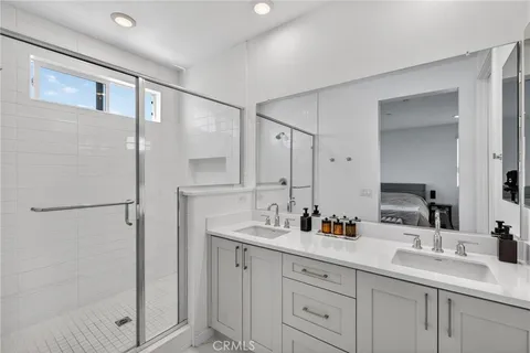 a bathroom with a double vanity sink mirror and double