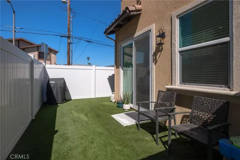 a view of backyard with barbeque grill and outdoor seating