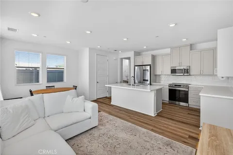 a living room with furniture and kitchen view