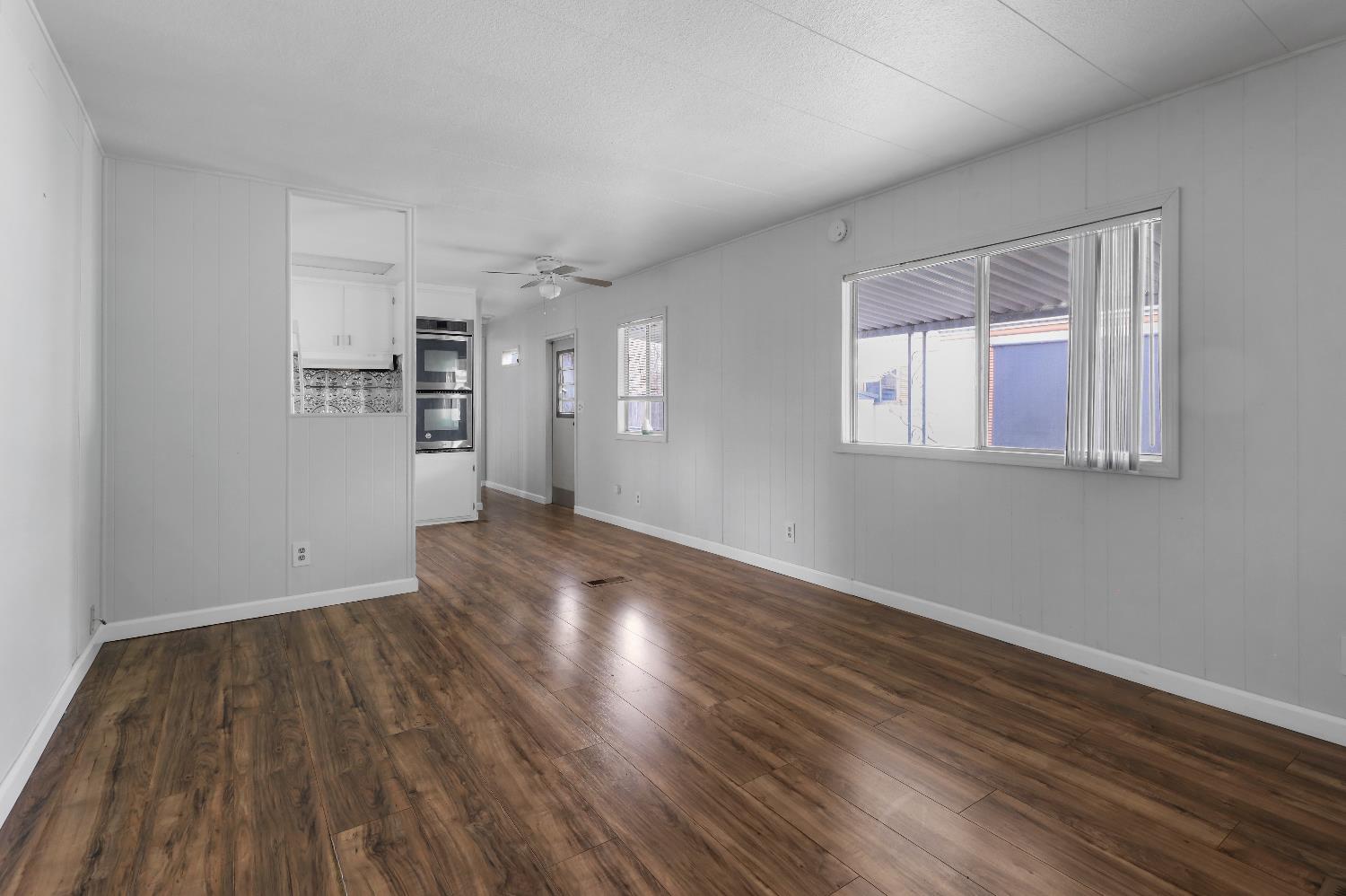 19142 North Jack Tone Road, Unit 34 Lockeford, CA 95237 - Photo 11 of 21 a view of empty room with wooden floor and fan