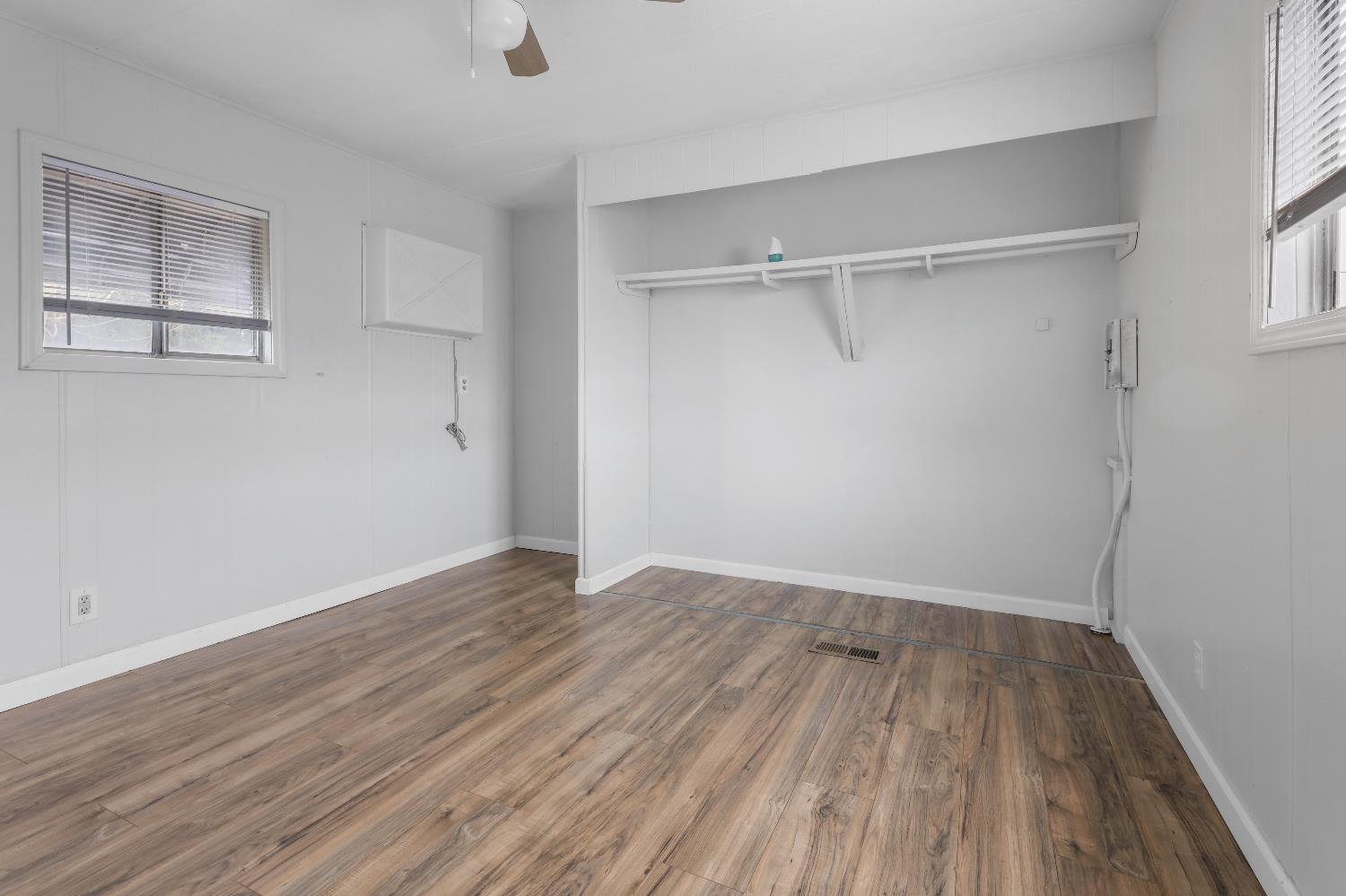 19142 North Jack Tone Road, Unit 34 Lockeford, CA 95237 - Photo 15 of 21 a view of an empty room with wooden floor window
