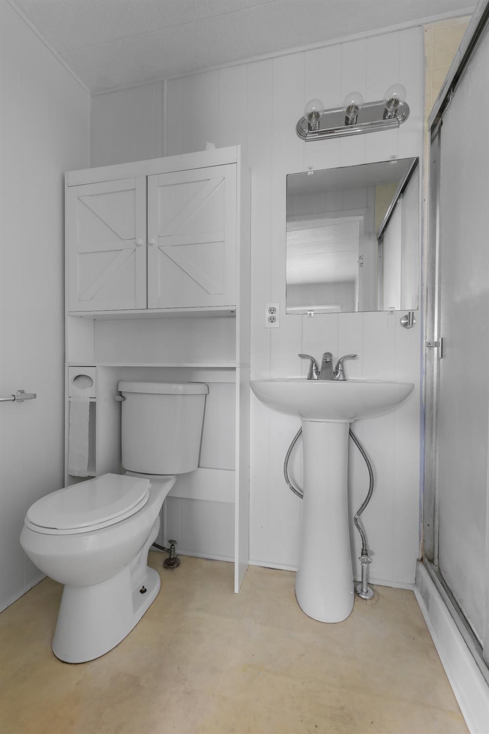 19142 North Jack Tone Road, Unit 34 Lockeford, CA 95237 - Photo 19 of 21 a white toilet sitting next to a bathroom sink