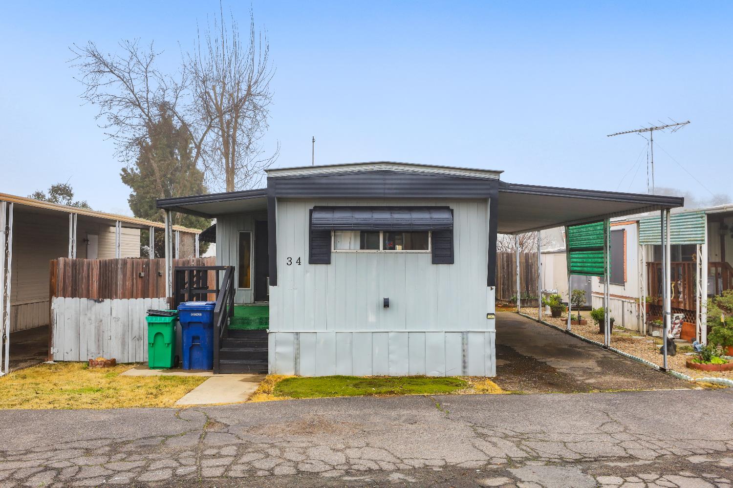 19142 North Jack Tone Road, Unit 34 Lockeford, CA 95237 - Photo 3 of 21 a view of house with yard and trees in the background