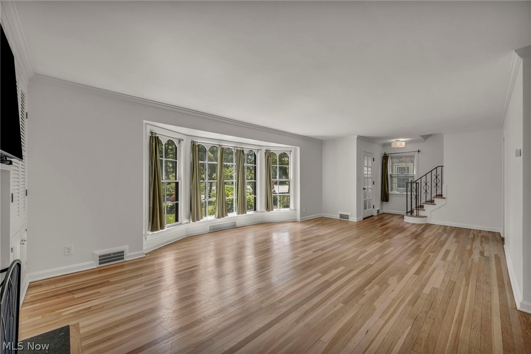 3543 Lytle Road Shaker Heights, OH 44122 - Photo 11 of 49 Spacious room featuring light wood-finish flooring, a bay window with arched panes, and white walls
