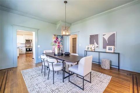 a kitchen with granite countertop a stove a sink and a refrigerator