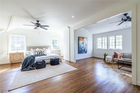a bathroom with a granite countertop sink a toilet and a shower
