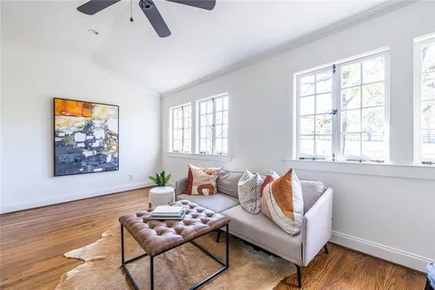 a bathroom with a granite countertop sink a mirror a vanity and shower