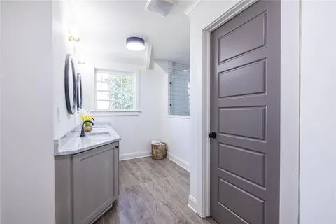 a bathroom with a tub sink and mirror