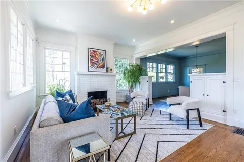 a living room with furniture a fireplace and a window