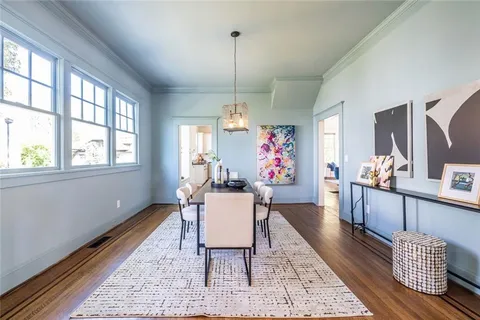 a view of a dining room with furniture window and wooden floor