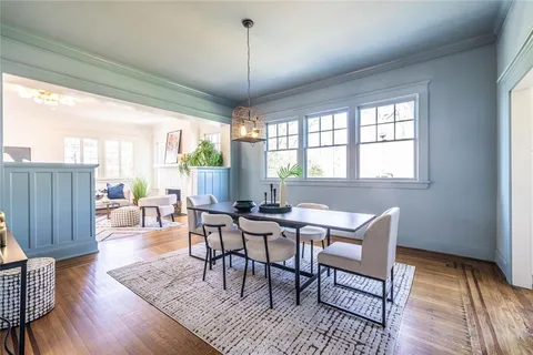a view of a dining room with furniture window and wooden floor