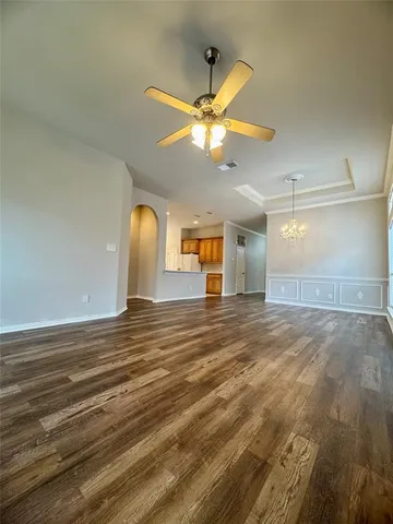 a view of a livingroom with a ceiling fan and window