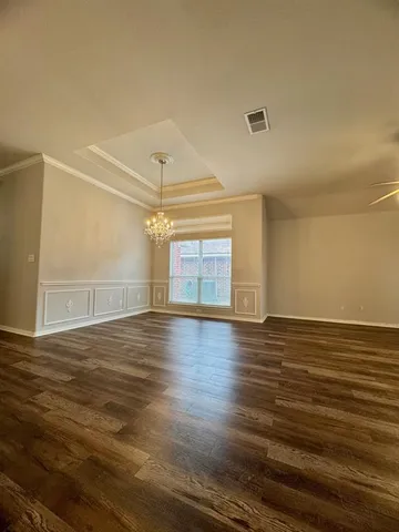 a view of a room with wooden floor and white walls