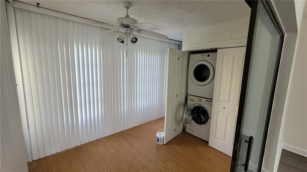 9273 Southwest 8th Street, Unit 109 Boca Raton, FL 33428 - Photo 4 of 20 a view of walk in closet with empty racks