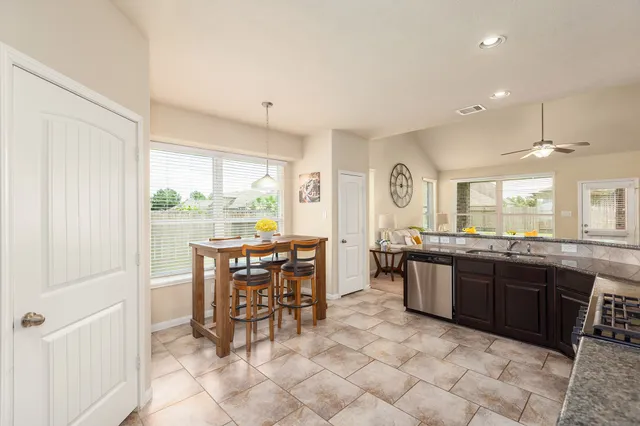 a large kitchen with a table and chairs