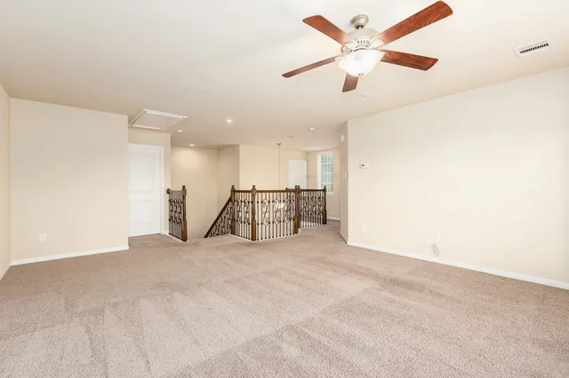a view of an empty room with a ceiling fan