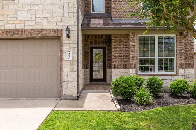 a front view of a house with garden